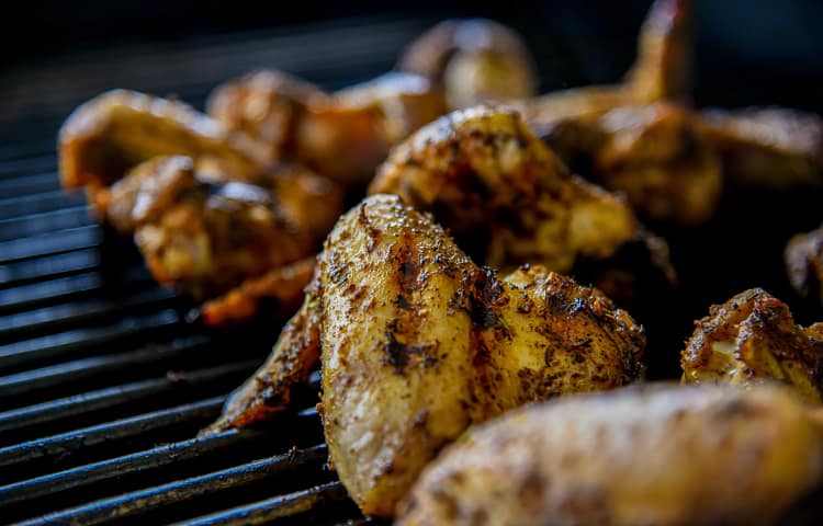 Chicken wings cooked over charcoal. Photo: David Todd McCarty